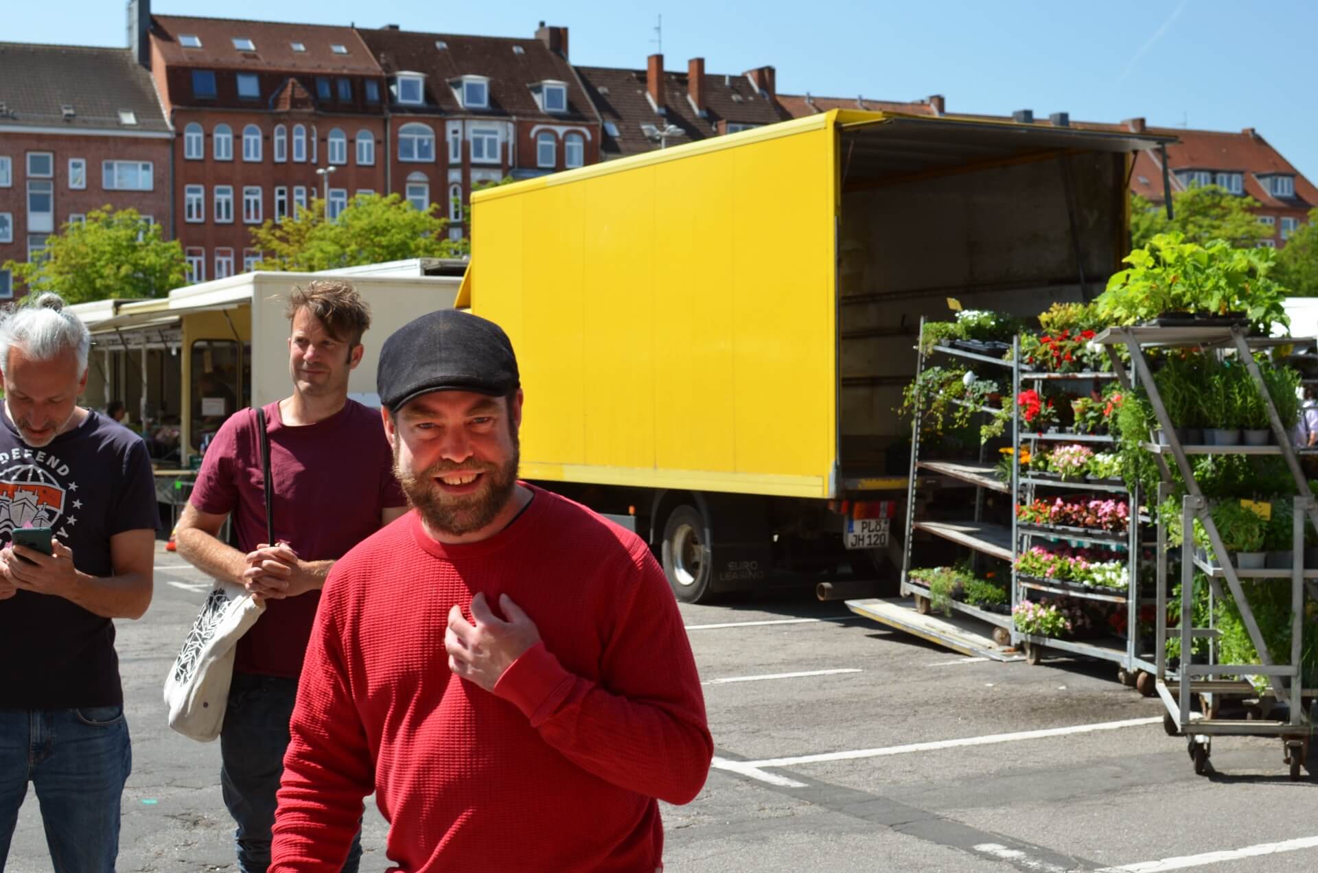 Björn Thoroe auf dem Wochenmarkt, er lacht in Richtung Kamera.